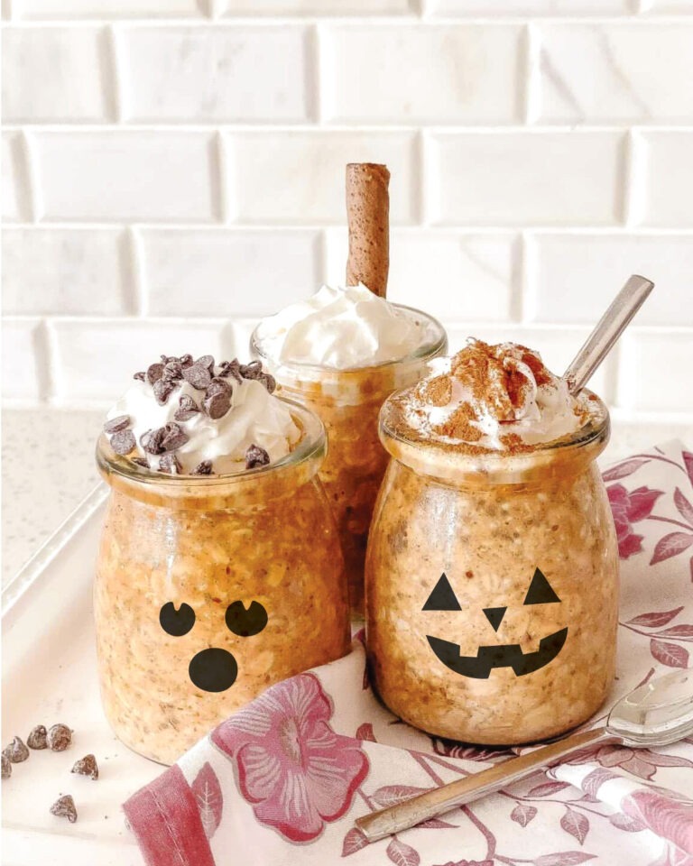 Pumpkin spice overnight oats individual portions with different toppings. Shown in glass jars with ghost and jack-o-lantern faces printed on them to make kid-friendly for Halloween