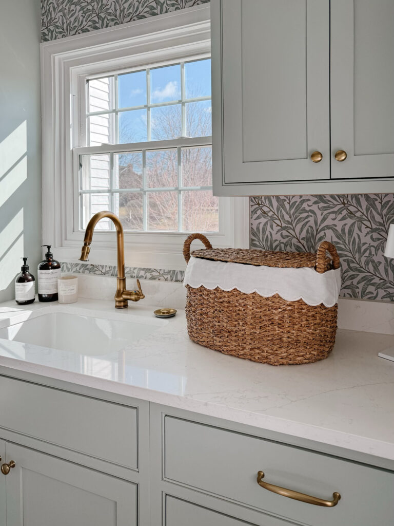 Green laundry room with checkered floor and botanical print wallpaper, laundry room ideas with stacked washer and dryer, laundry room ideas stacked, remodeled laundry room, Checkered floor tile, checkered floor, ceramic checkered floor, inset cabinets, green cabinetry, sherwin williams comfort gray